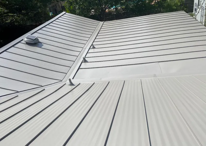 Solar attic fan installed on a metal roof for Roof Ventilation in Maple Grove